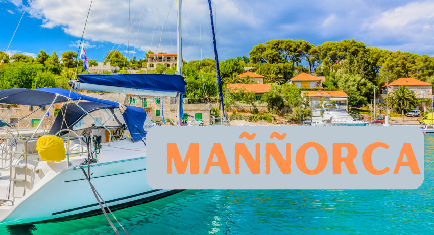 A sailboat docked in a picturesque harbor with clear turquoise waters, lush green trees, and charming buildings in the background. The text "MAÑÑORCA" is prominently displayed over the image.